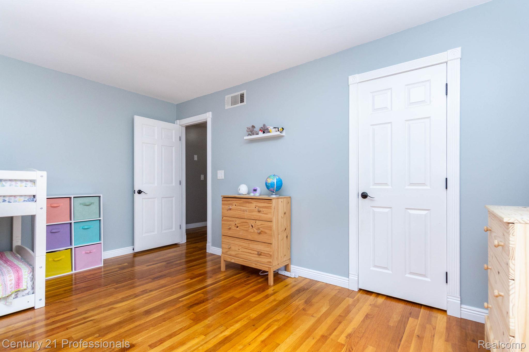 671 Bridgestone Drive Rochester, MI 48309 - Photo 32 of 50 Room featuring wood-finish flooring, light blue walls, and white trim