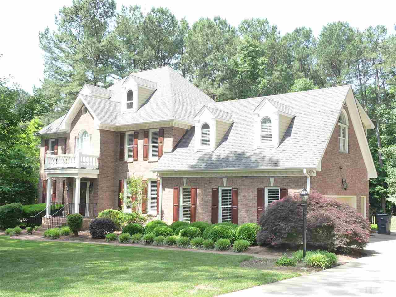 4733 Sharpstone Lane Raleigh, NC 27615 - Photo 1 of 23 a front view of a house with a yard and potted plants