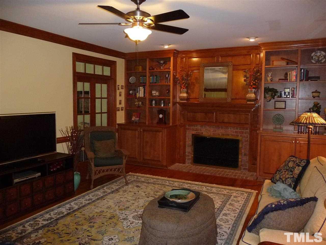 4733 Sharpstone Lane Raleigh, NC 27615 - Photo 14 of 23 a living room with furniture a flat screen tv and a fireplace