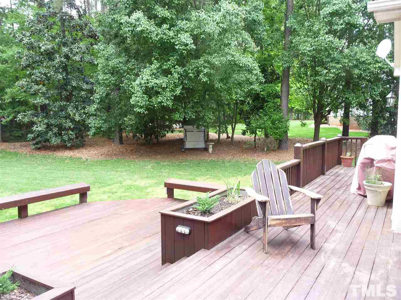 4733 Sharpstone Lane Raleigh, NC 27615 - Photo 17 of 23 a view of a patio with dining table and chairs with wooden floor and fence