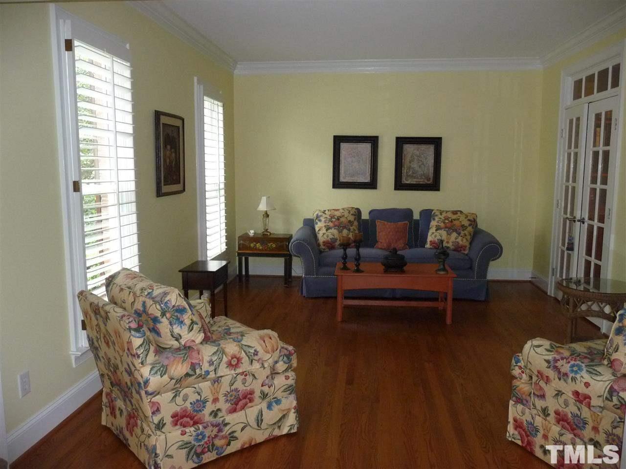 4733 Sharpstone Lane Raleigh, NC 27615 - Photo 4 of 23 a living room with furniture and a potted plant