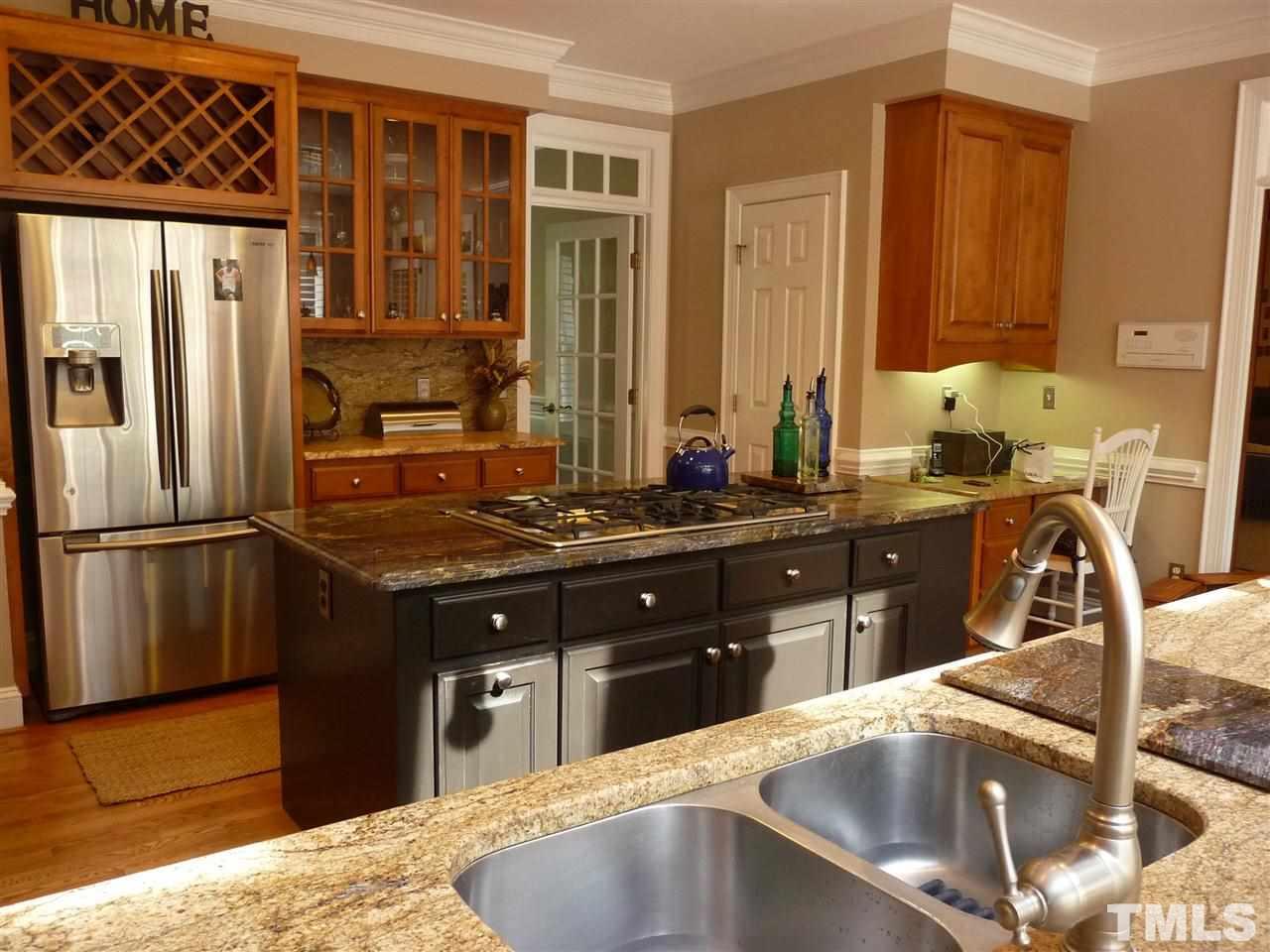 4733 Sharpstone Lane Raleigh, NC 27615 - Photo 5 of 23 a kitchen with a sink refrigerator and microwave