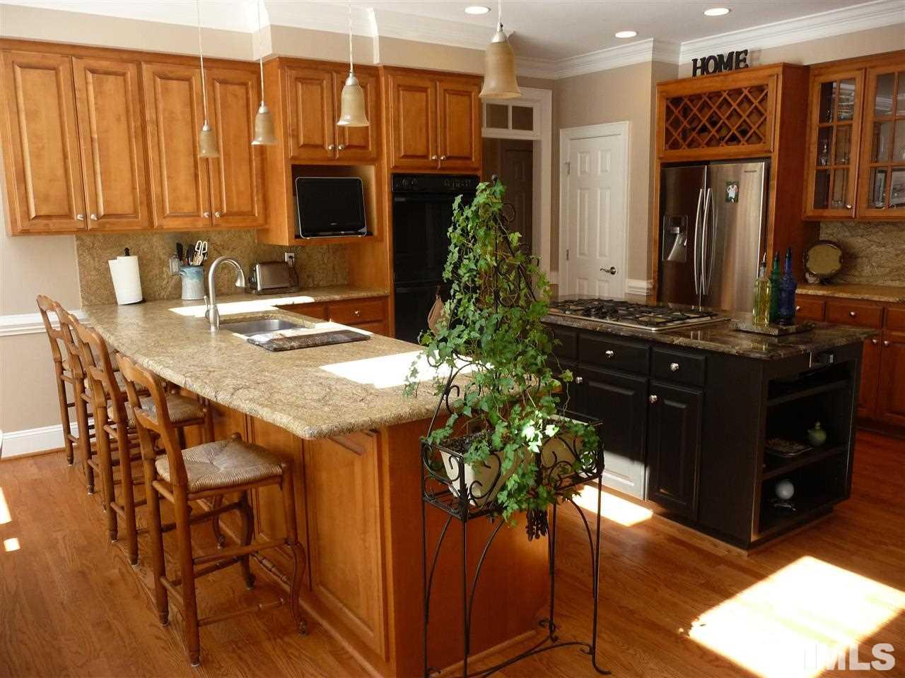 4733 Sharpstone Lane Raleigh, NC 27615 - Photo 7 of 23 a kitchen with a table and chairs