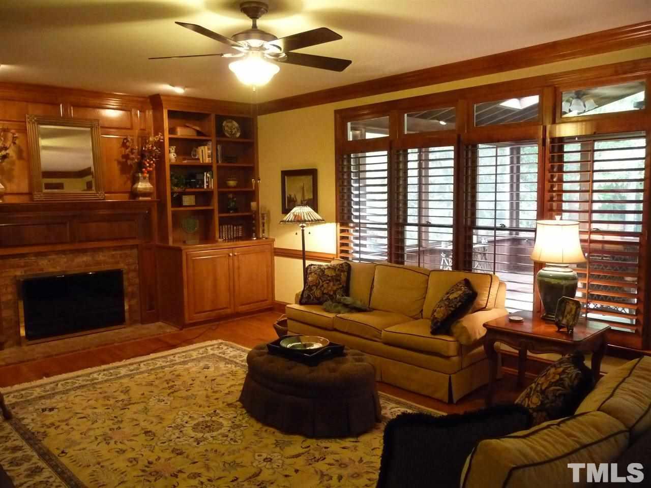4733 Sharpstone Lane Raleigh, NC 27615 - Photo 8 of 23 a living room with furniture a fireplace and a flat screen tv