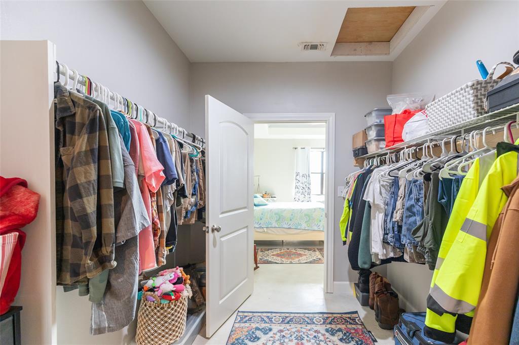 760 Wimberly Road Merkel, TX 79536 - Photo 22 of 35 Walk-in closet featuring built-in shelving, hanging rods, and a white interior door with a rounded arch panel
