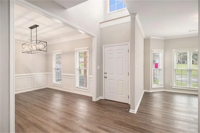 a view of a livingroom with wooden floor and stairs