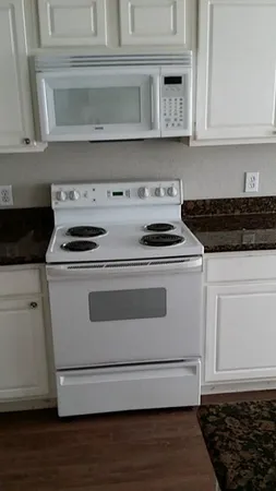 a stove top oven sitting inside of a kitchen