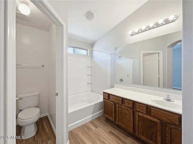a spacious bathroom with a shower sink vanity mirror and toilet