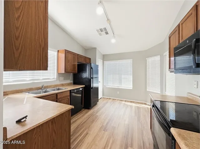 a kitchen with a sink stove top oven and refrigerator