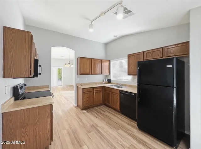 a kitchen with a refrigerator and a sink
