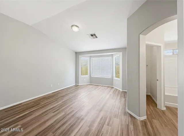 wooden floor in an empty room with a window