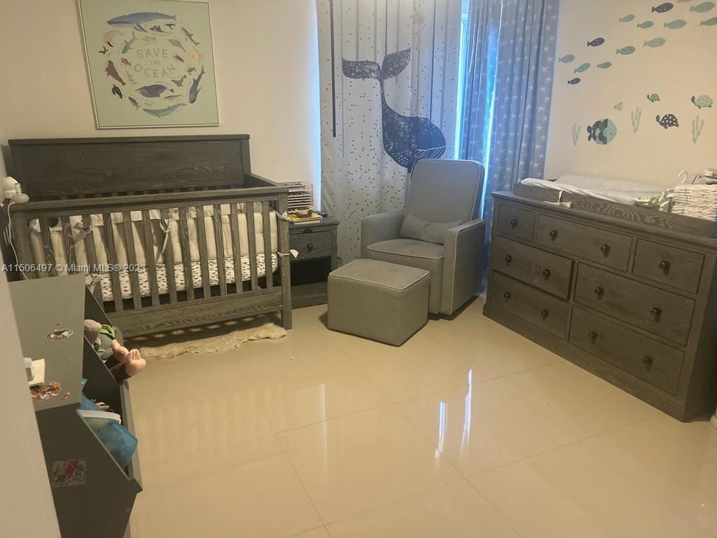 Coral Gate Miami, FL 33145 - Photo 9 of 13 a bedroom with a bed and wall painting