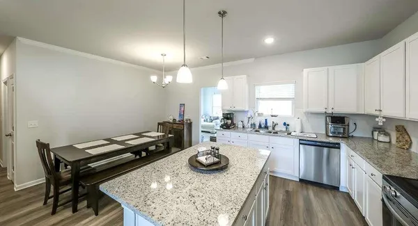 a kitchen with sink refrigerator and stove