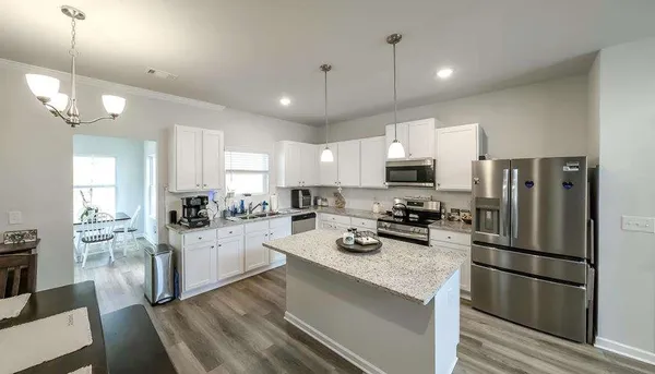a kitchen with sink a refrigerator and cabinets