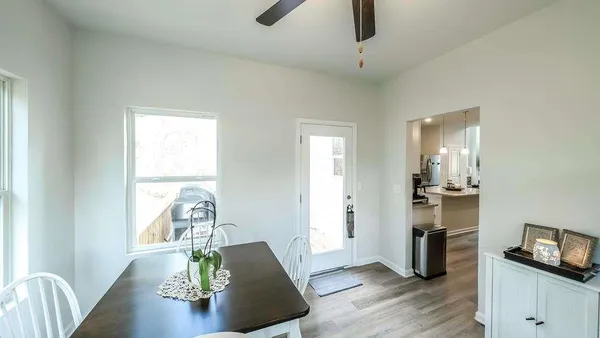 a bathroom with a granite countertop toilet and a sink