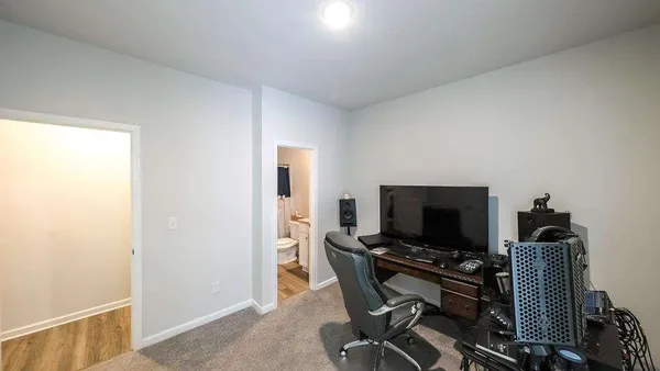 a view of a workspace with furniture and a flat screen tv
