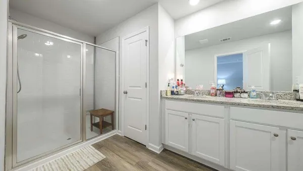 a view of a room with wooden floor and a sink