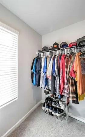 a bedroom with a bed and a flat tv screen on dresser