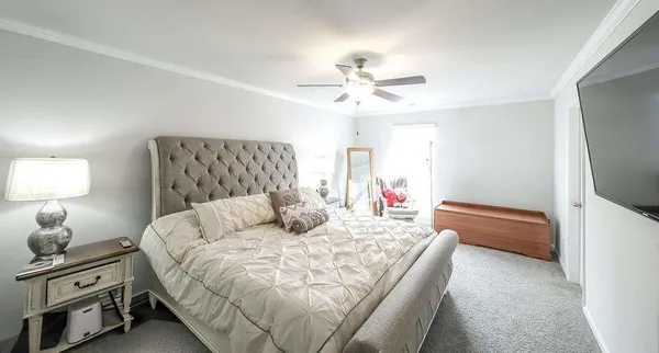 a bedroom with a large bed and a flat screen tv