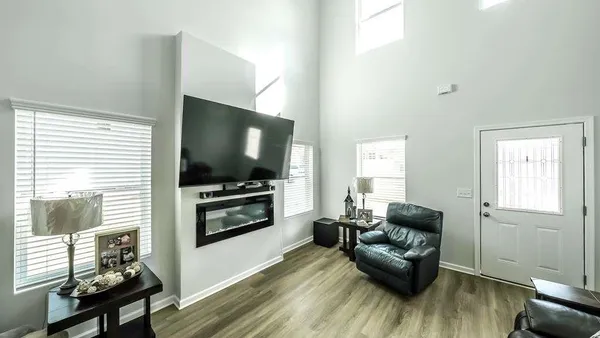a living room with furniture and a flat screen tv