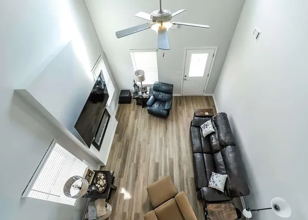 a living room with furniture and a chandelier