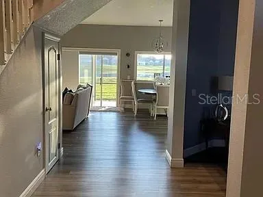 a hallway with wooden floor and furniture