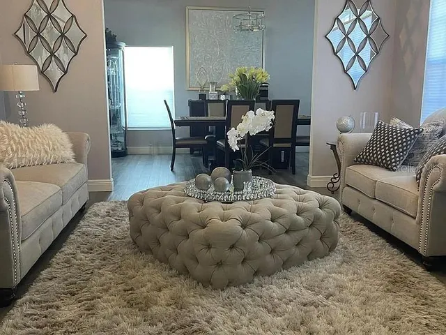 a living room with furniture and a large window