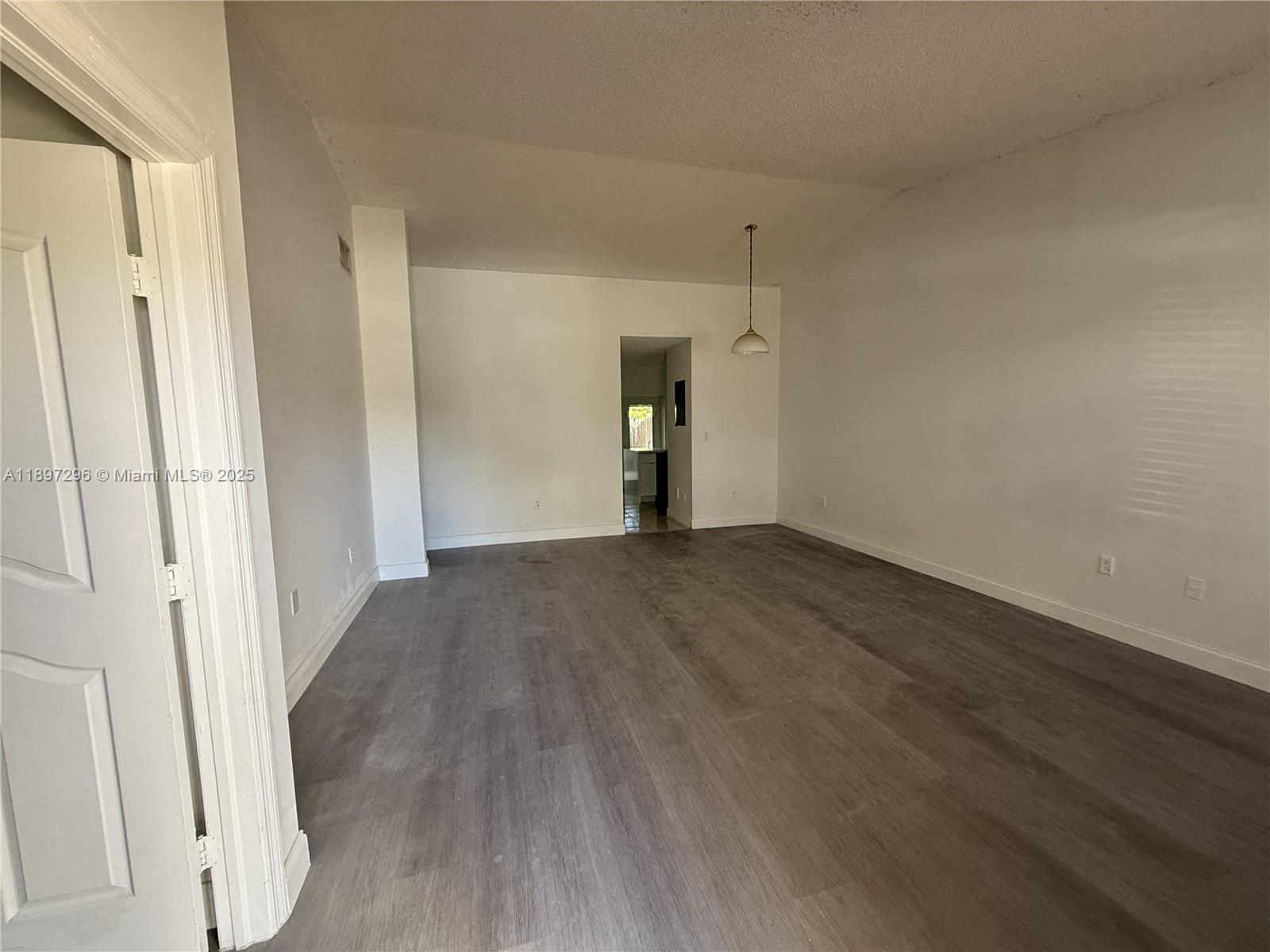 18942 Northwest 86th Court, Unit 4106 Hialeah, FL 33015 - Photo 1 of 10 a view of empty room with wooden floor