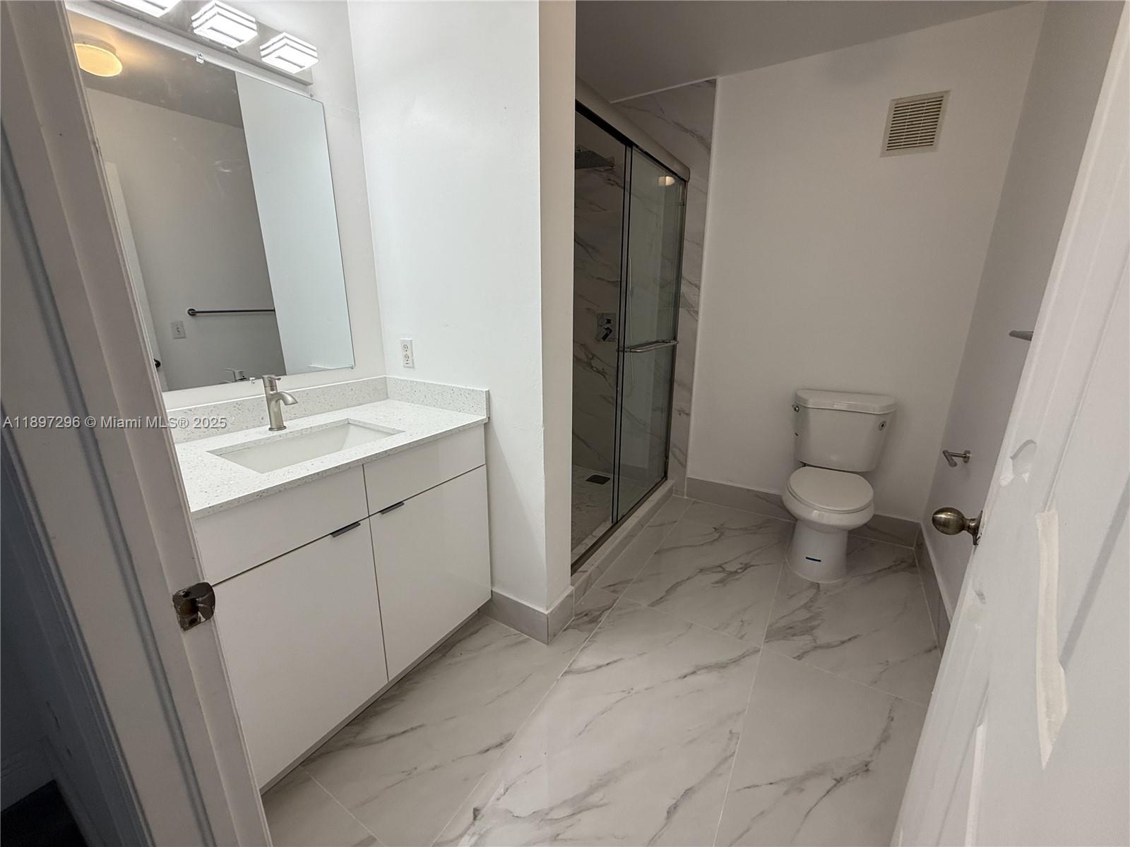 18942 Northwest 86th Court, Unit 4106 Hialeah, FL 33015 - Photo 2 of 10 a bathroom with a sink and a mirror