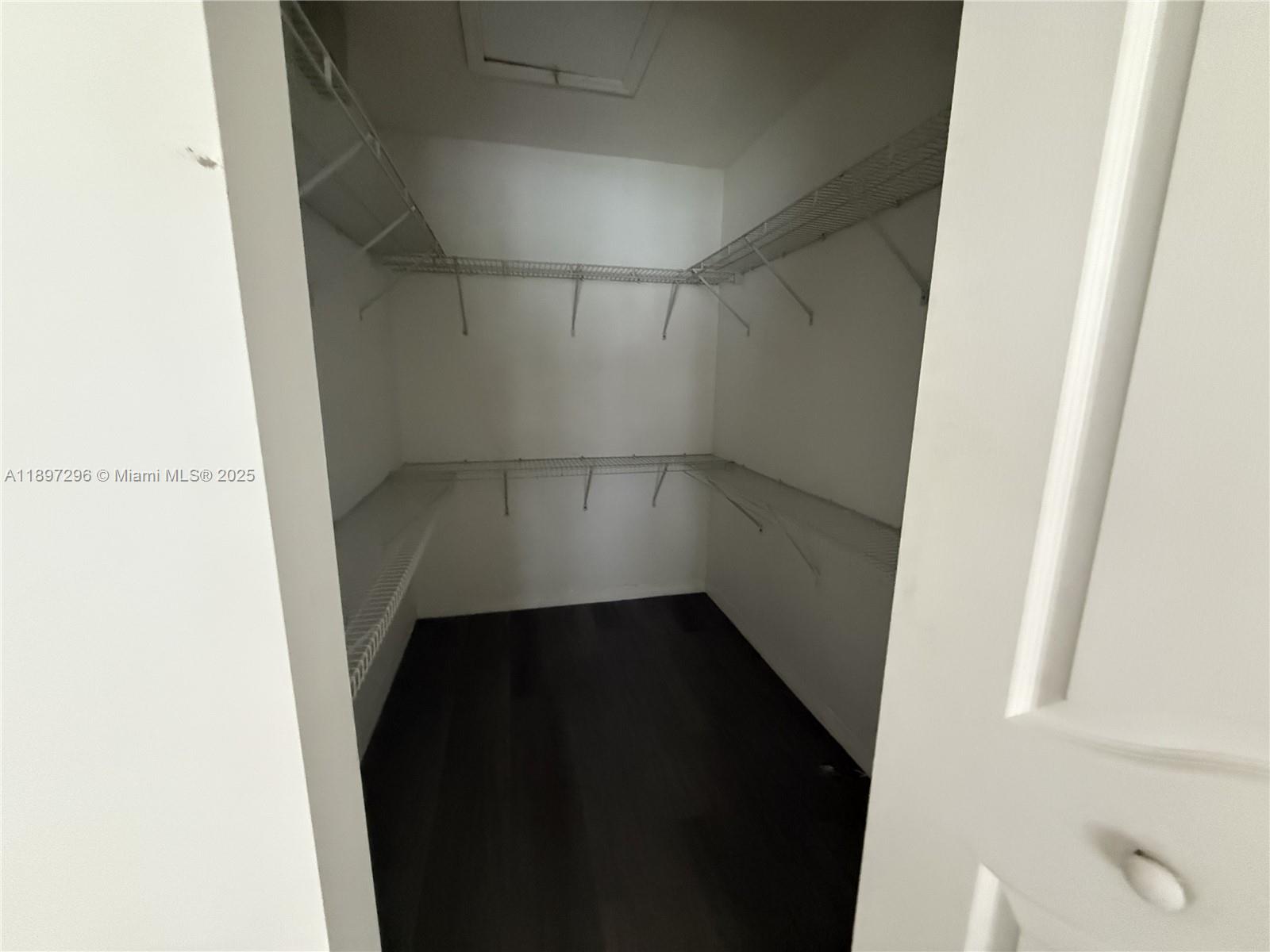 18942 Northwest 86th Court, Unit 4106 Hialeah, FL 33015 - Photo 3 of 10 a view of an empty walk in closet