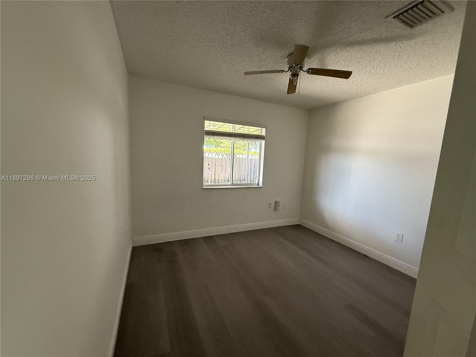 18942 Northwest 86th Court, Unit 4106 Hialeah, FL 33015 - Photo 8 of 10 an empty room with windows and entrance