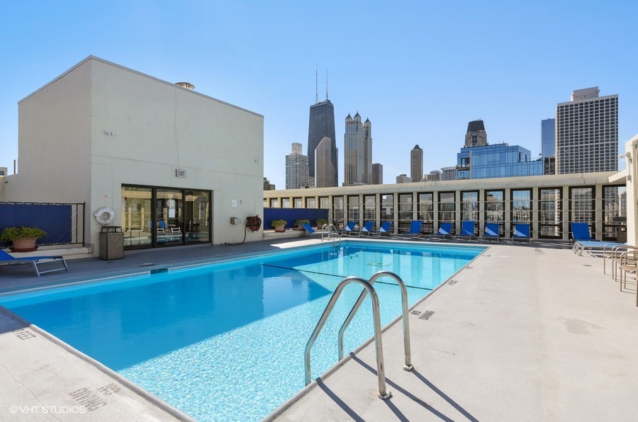 1 East Scott Street, Unit 2307 Chicago, IL 60610 - Photo 11 of 14 a view of a swimming pool with a lounge chair