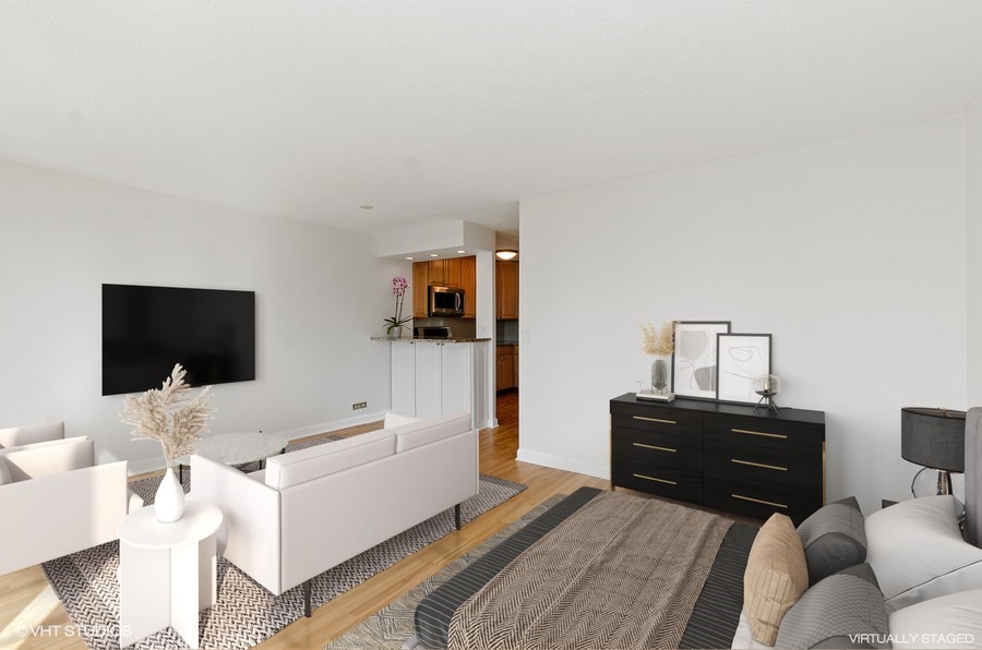 1 East Scott Street, Unit 2307 Chicago, IL 60610 - Photo 3 of 14 a living room with furniture and a flat screen tv