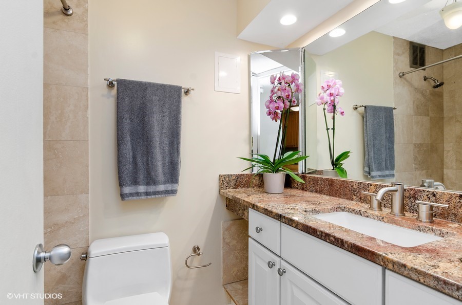 1 East Scott Street, Unit 2307 Chicago, IL 60610 - Photo 9 of 14 a bathroom with a granite countertop sink and a mirror