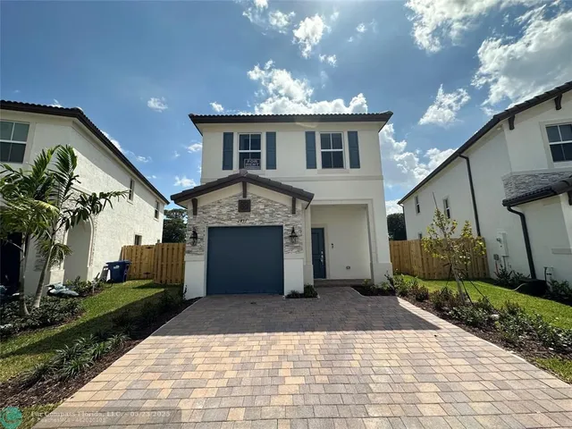 a view of a house with a yard and potted plants