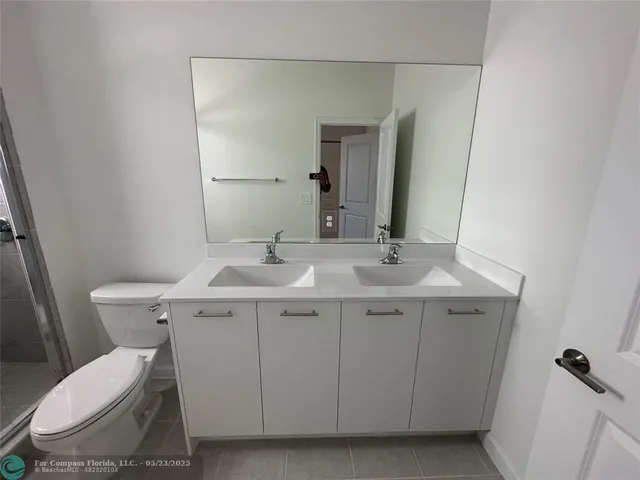 a bathroom with a sink toilet and mirror