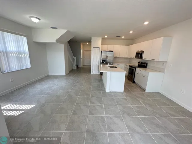 a kitchen with a sink stainless steel appliances and cabinets