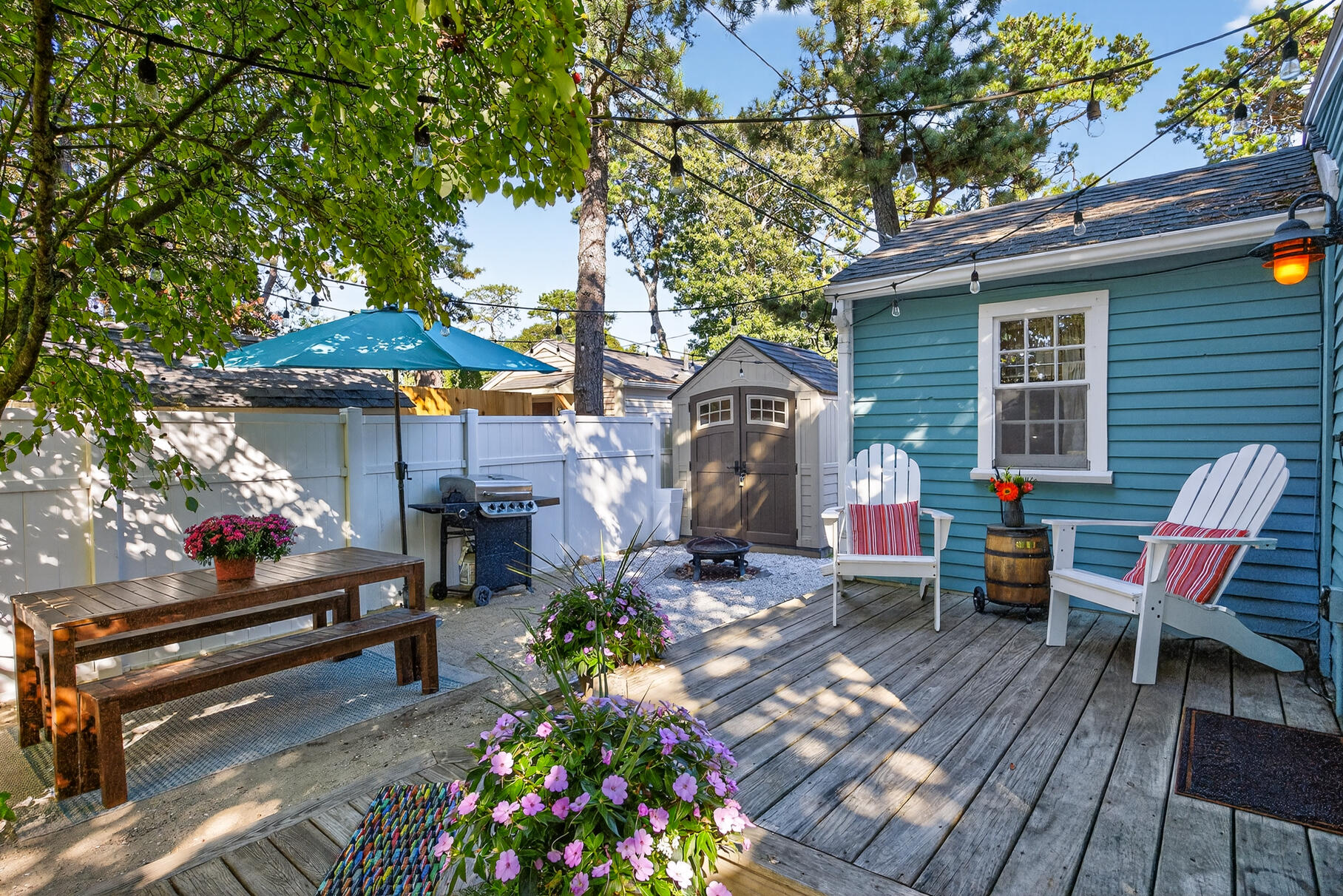 262 Old Wharf Road, Unit U27 Dennis Port, MA 02639 - Photo 2 of 37 a patio with sofas table and chairs under an umbrella