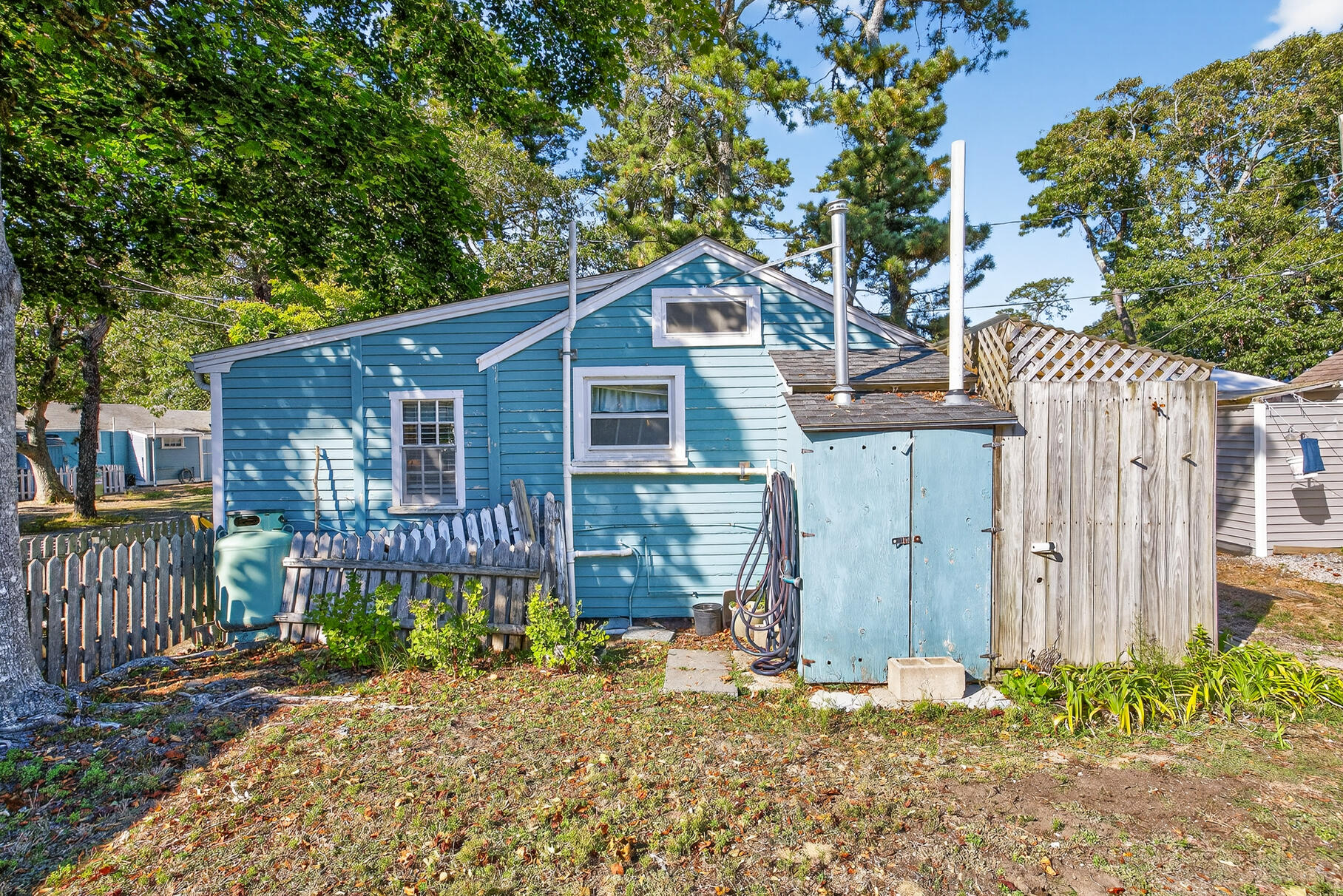 262 Old Wharf Road, Unit U27 Dennis Port, MA 02639 - Photo 29 of 37 a wooden house with trees in front of it
