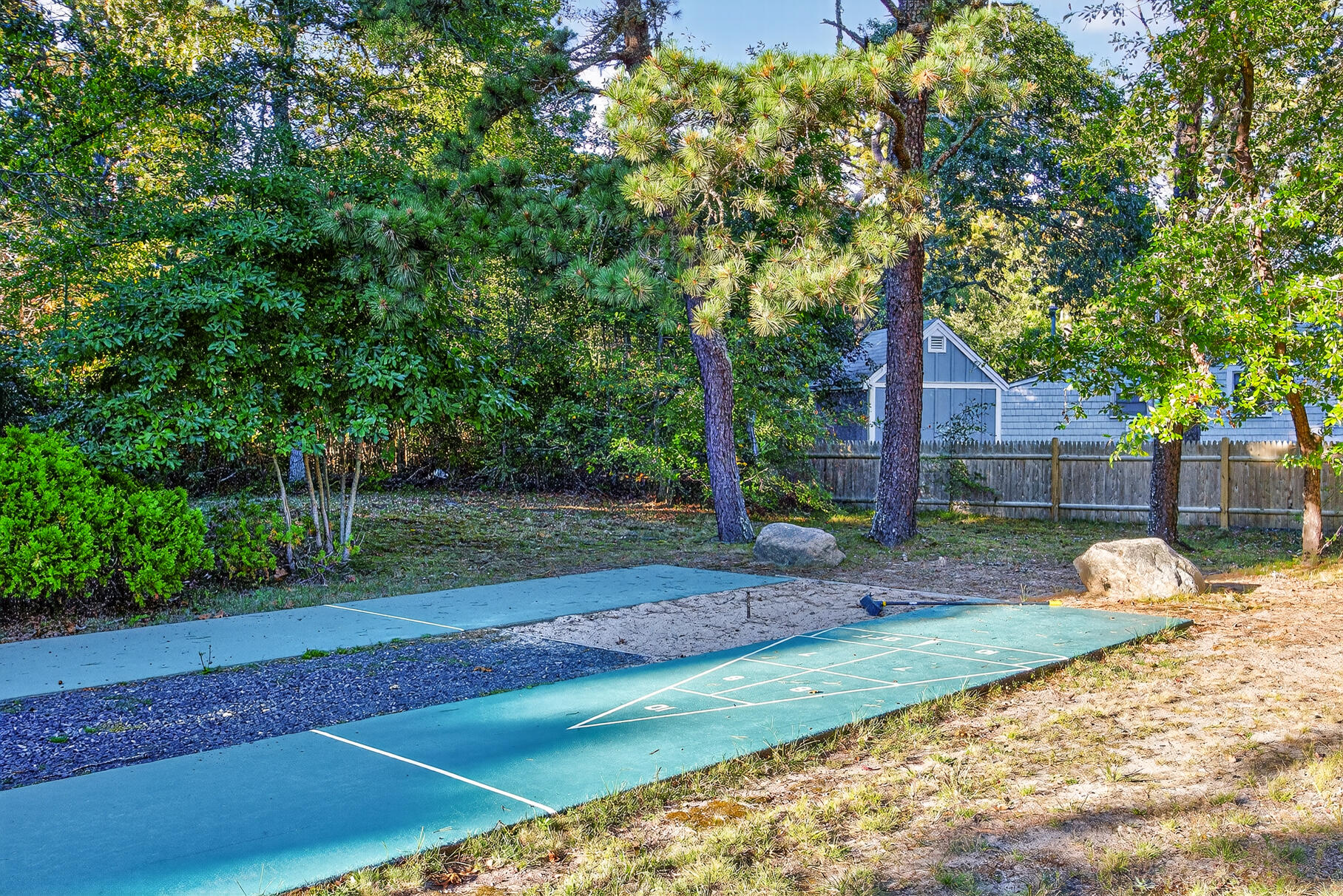 262 Old Wharf Road, Unit U27 Dennis Port, MA 02639 - Photo 36 of 37 a view of a backyard with large trees and wooden fence