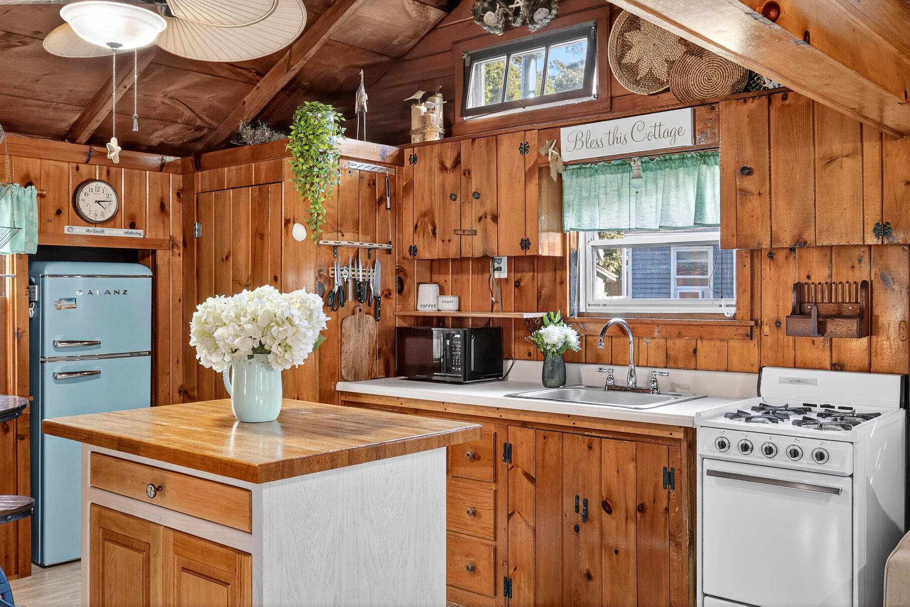 262 Old Wharf Road, Unit U27 Dennis Port, MA 02639 - Photo 5 of 37 a kitchen with a stove a table and chairs