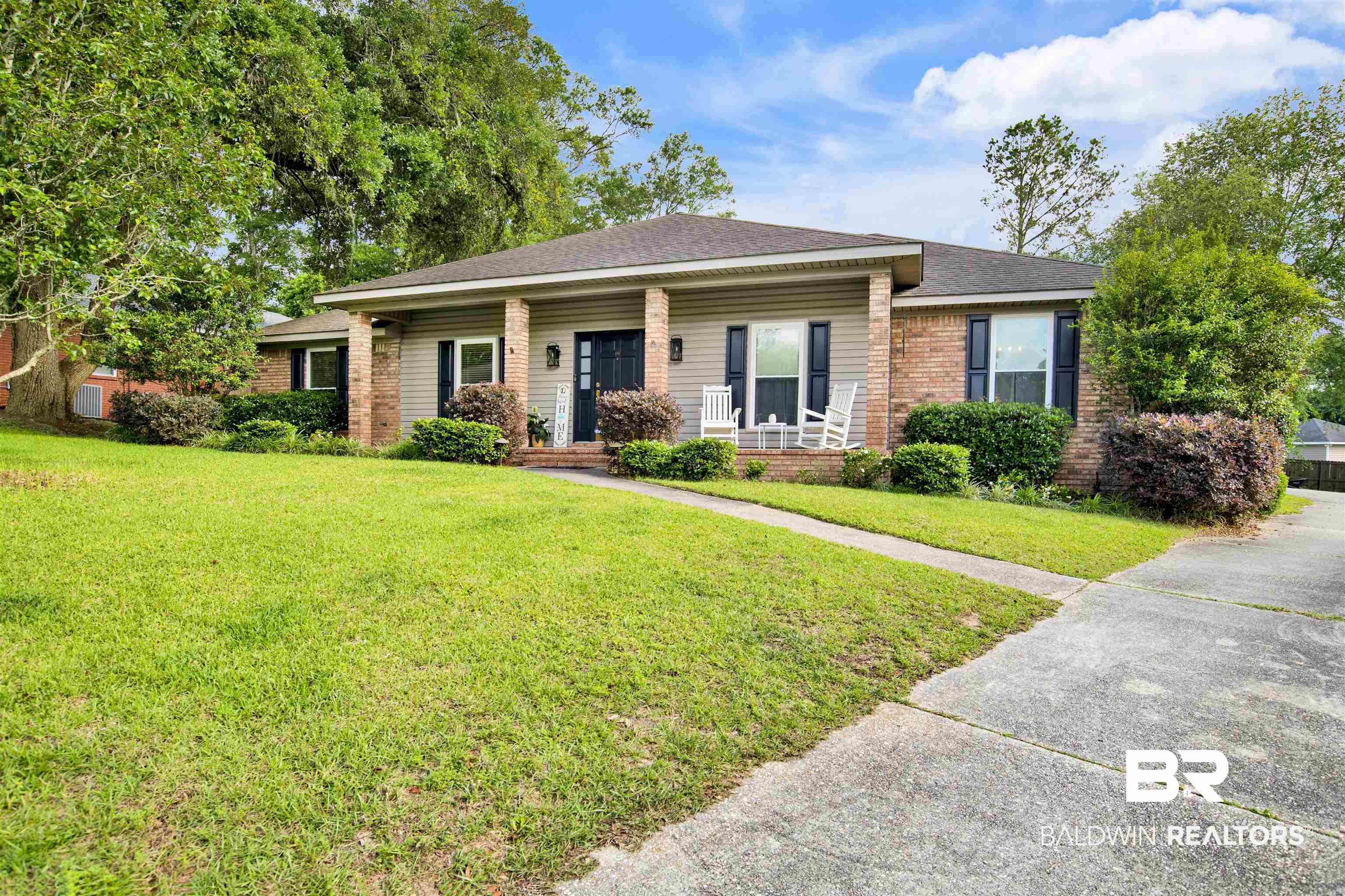 7431 Summer Court Mobile, AL 36695 - Photo 2 of 37 View of front facade with a porch, brick siding, a front lawn, and a shingled roof