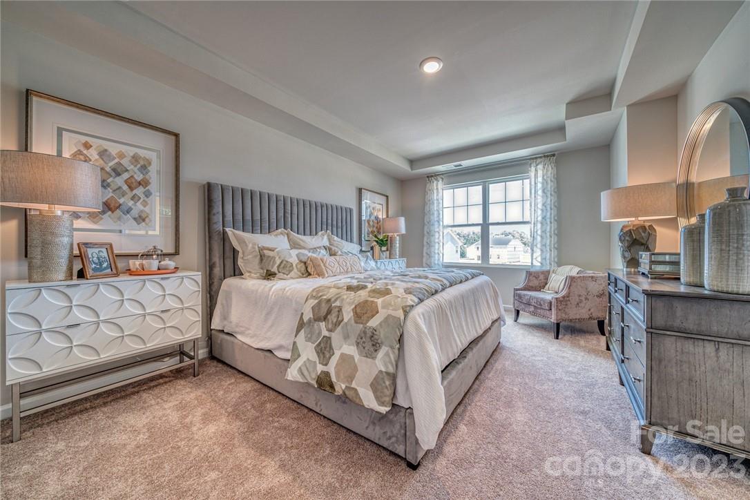 7020 Everly Commons Lane, Unit 2026 Tega Cay, SC 29708 - Photo 6 of 12 a spacious bedroom with a bed and window