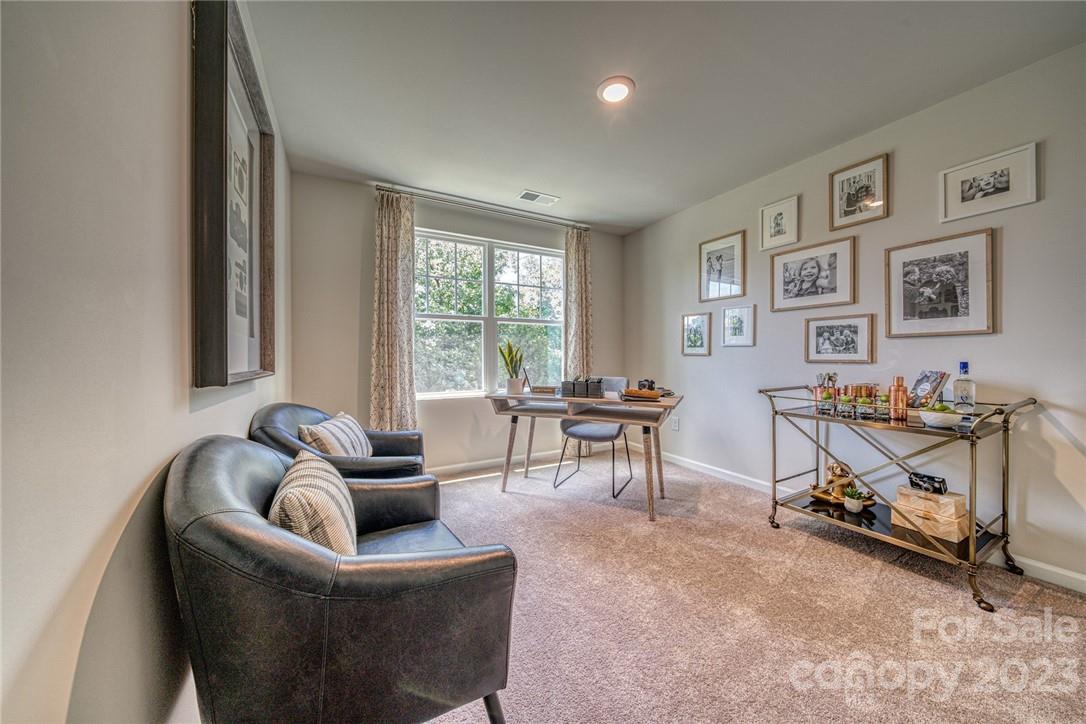 7020 Everly Commons Lane, Unit 2026 Tega Cay, SC 29708 - Photo 9 of 12 a living room with furniture and a window