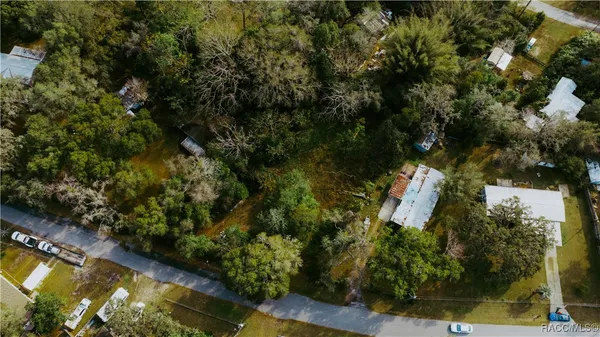 an aerial view of a house with swimming pool and garden
