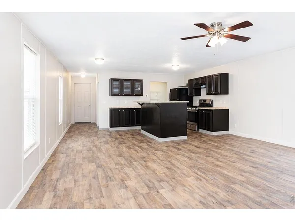 a large kitchen with kitchen island a sink stainless steel appliances and cabinets