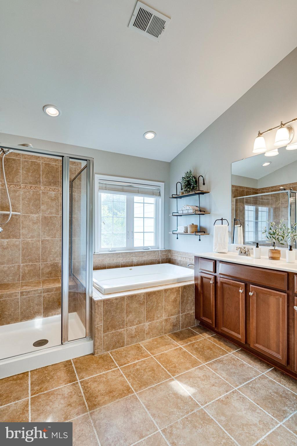 9167 Furey Road Lorton, VA 22079 - Photo 30 of 55 Primary bath has vaulted ceilings and private W.C.