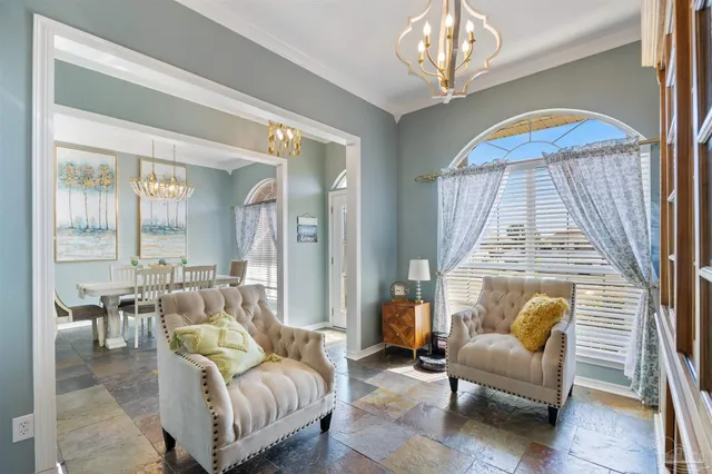 a view of a dining room with furniture and chandelier