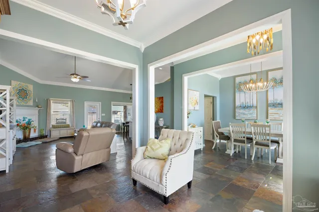 a view of a dining room with furniture and a chandelier