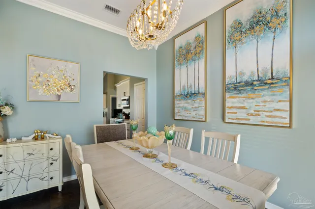 a view of a dining room with furniture wooden floor and chandelier